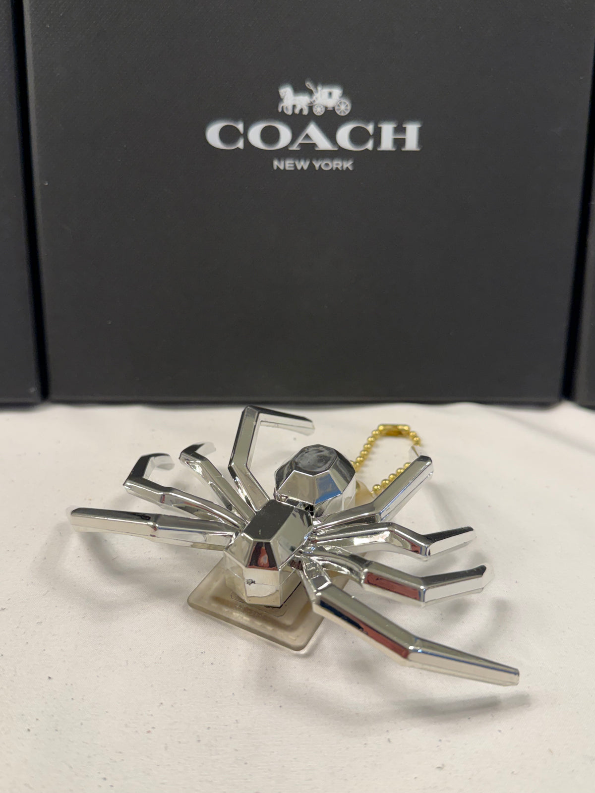 Repurposed Coach Clear (Yellowed) Hangtag with Metallic Plastic Spider Emblem