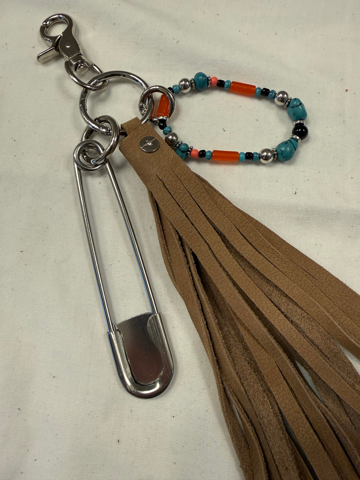 Bag Charm Cluster with Pebbled Leather Sandstone Tassel, Beaded Bracelet, and XL Safety Pin