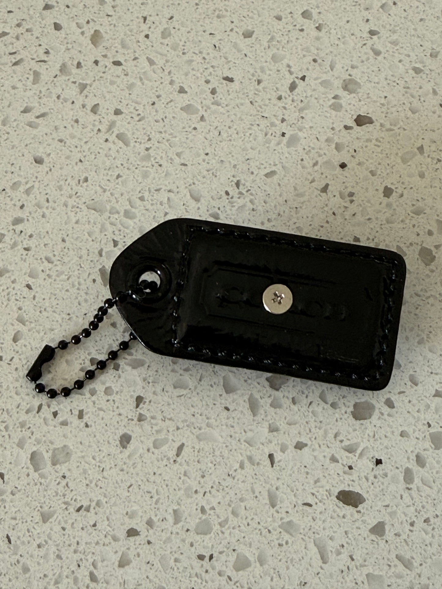 Repurposed Painted Black Coach Hangtag with Skull Rivet