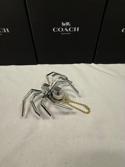 Repurposed Coach Clear (Yellowed) Hangtag with Metallic Plastic Spider Emblem
