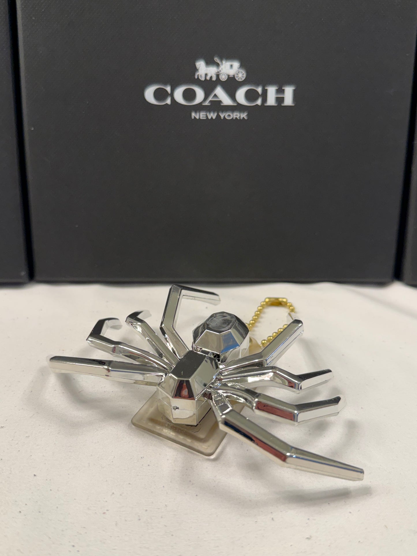 Repurposed Coach Clear (Yellowed) Hangtag with Metallic Plastic Spider Emblem