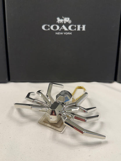 Repurposed Coach Clear (Yellowed) Hangtag with Metallic Plastic Spider Emblem