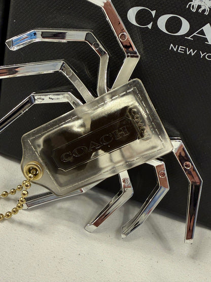 Repurposed Coach Clear (Yellowed) Hangtag with Metallic Plastic Spider Emblem