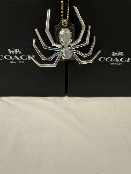 Repurposed Coach Clear (Yellowed) Hangtag with Metallic Plastic Spider Emblem