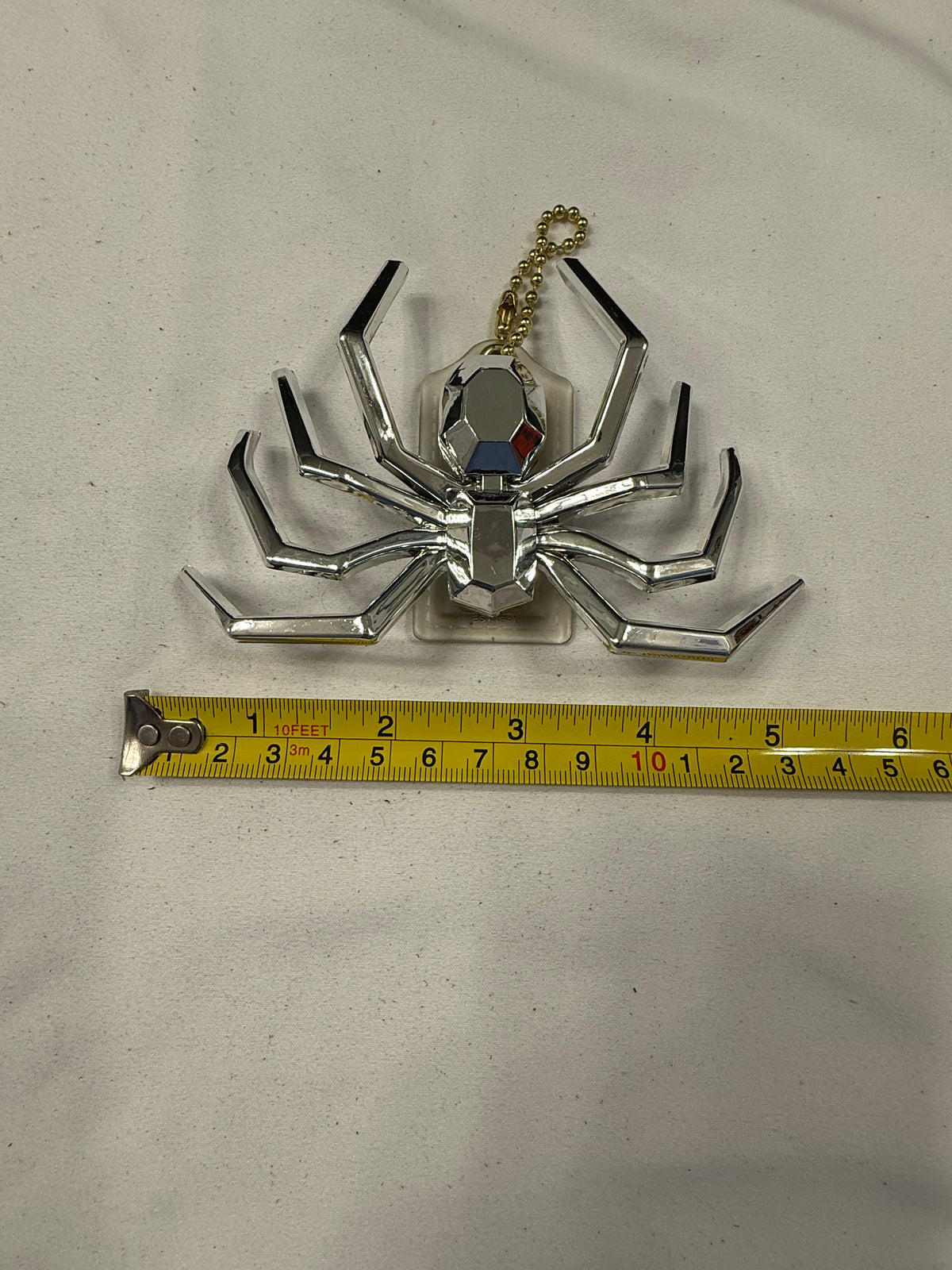 Repurposed Coach Clear (Yellowed) Hangtag with Metallic Plastic Spider Emblem