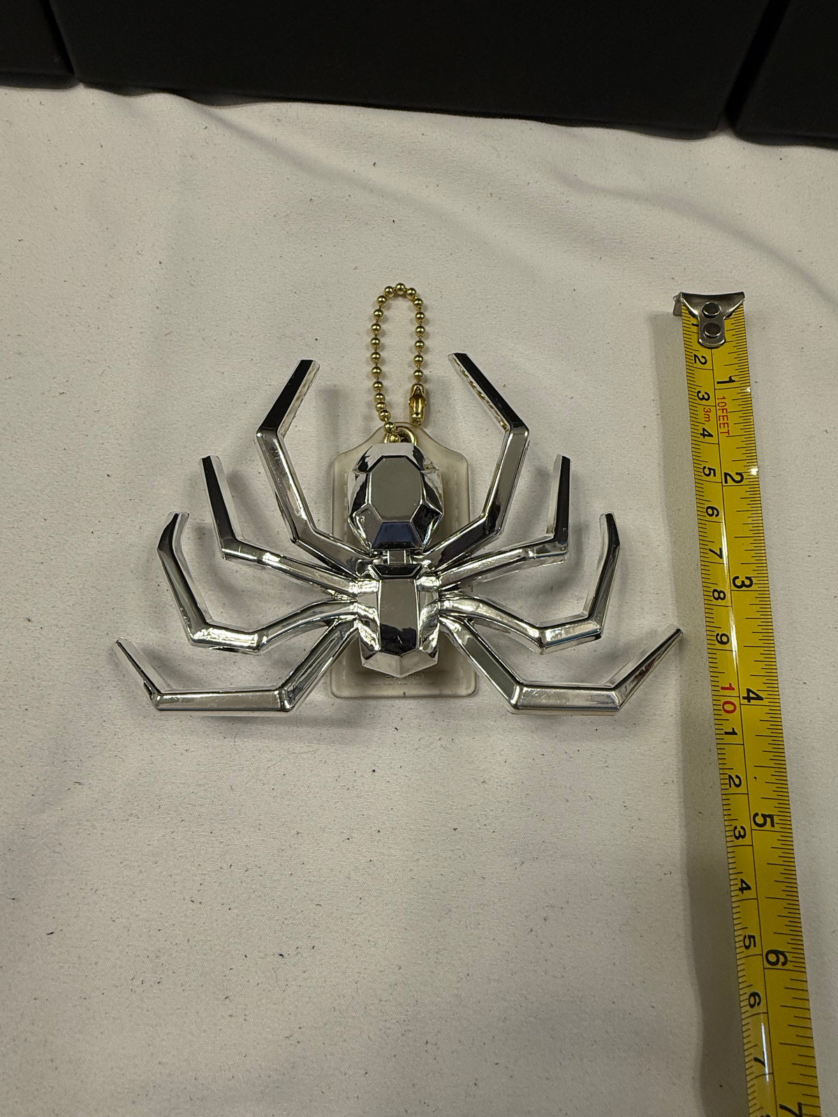 Repurposed Coach Clear (Yellowed) Hangtag with Metallic Plastic Spider Emblem