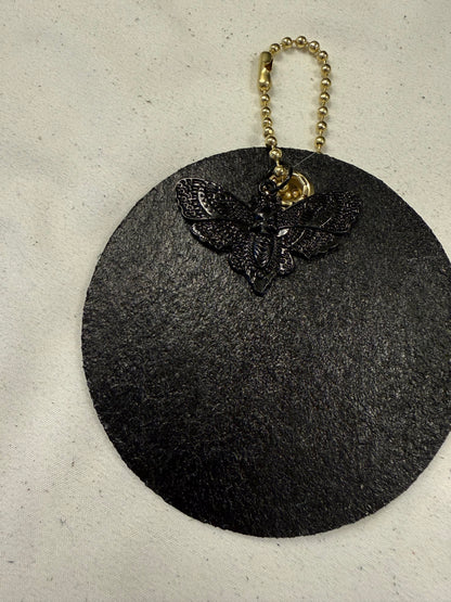 Stenciled and Painted Leather Disc with Butterfly and Skull Moth Charm