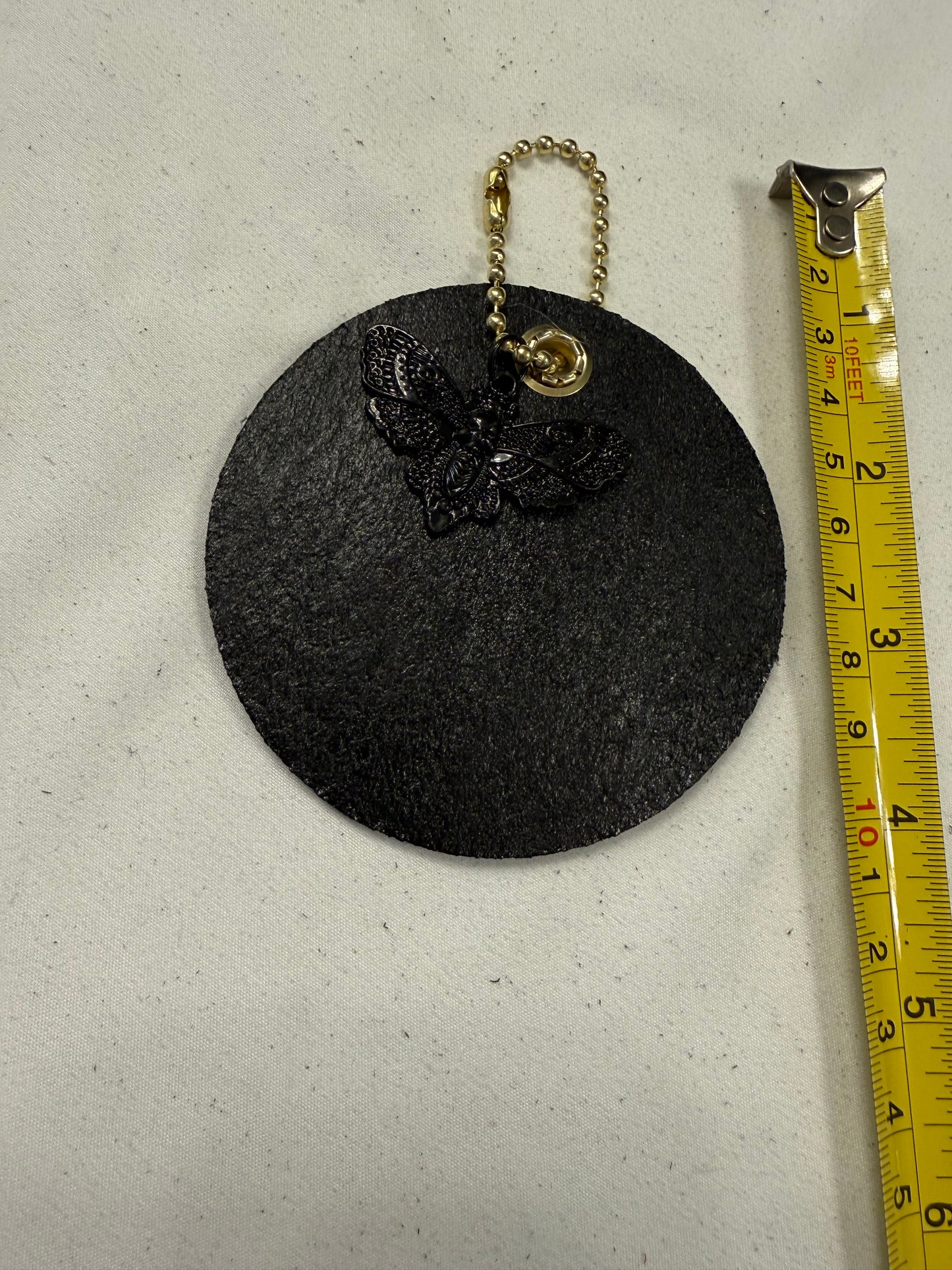Stenciled and Painted Leather Disc with Butterfly and Skull Moth Charm