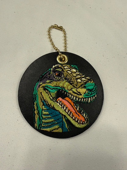 Repurposed Center of a Coach Coaster with Embroidered T-Rex Patch Bag Charm