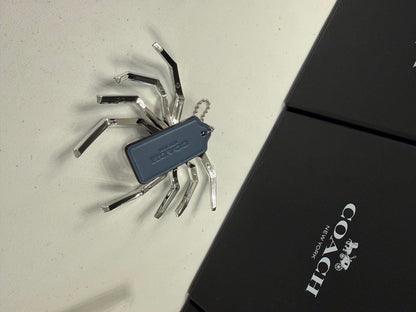 Repurposed Coach Blue Hangtag Bag Charm with Metallic Plastic Spider Emblem