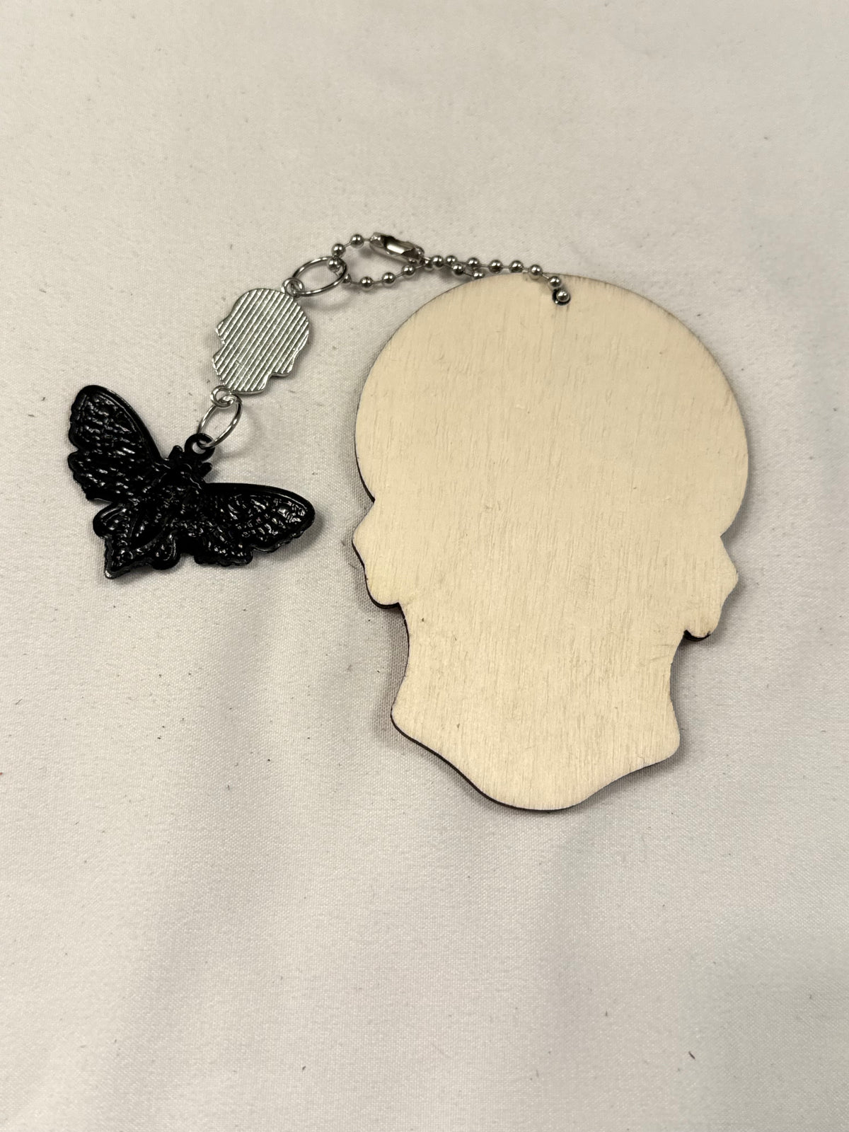 Green Sugar Skull Embossed on Wood with a Sugar Skull and Skull Moth Charm Bag Charm
