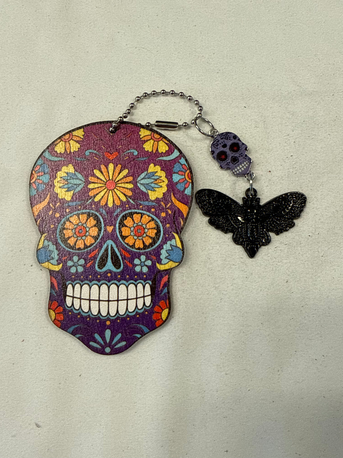 Purple Sugar Skull Embossed on Wood and Sugar Skull and Skull Moth Charm Bag Charm