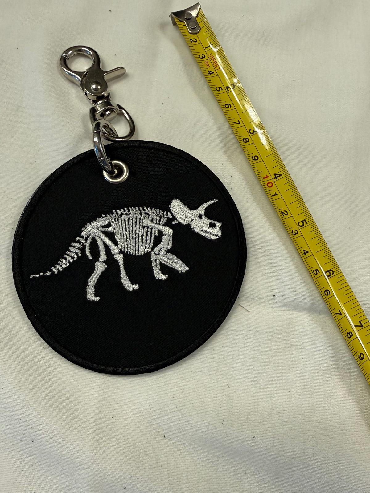 Dinosaur Skeleton Patch on a Piece of Repurposed Coach Handbag Bag Charm