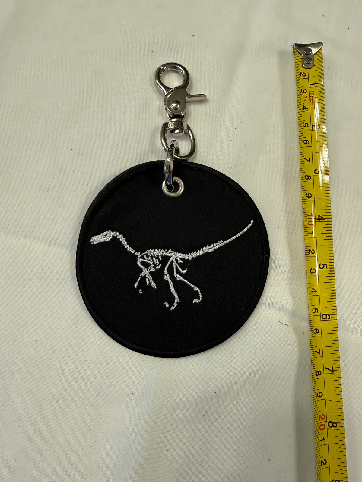 Dinosaur Skeleton Patch on a Piece of Repurposed Coach Handbag Bag Charm