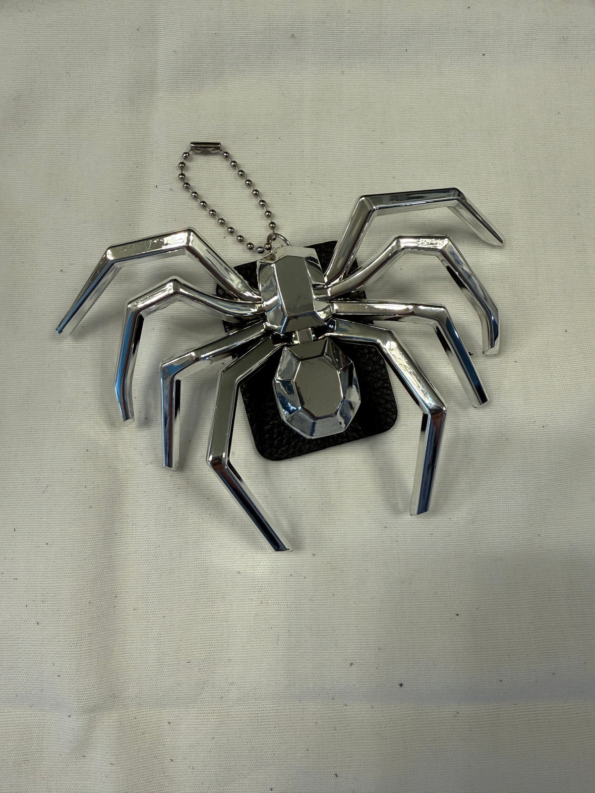 Metallic Plastic Spider on a Piece of a Coach Lora Bucket Bag Hangtag Style Charm