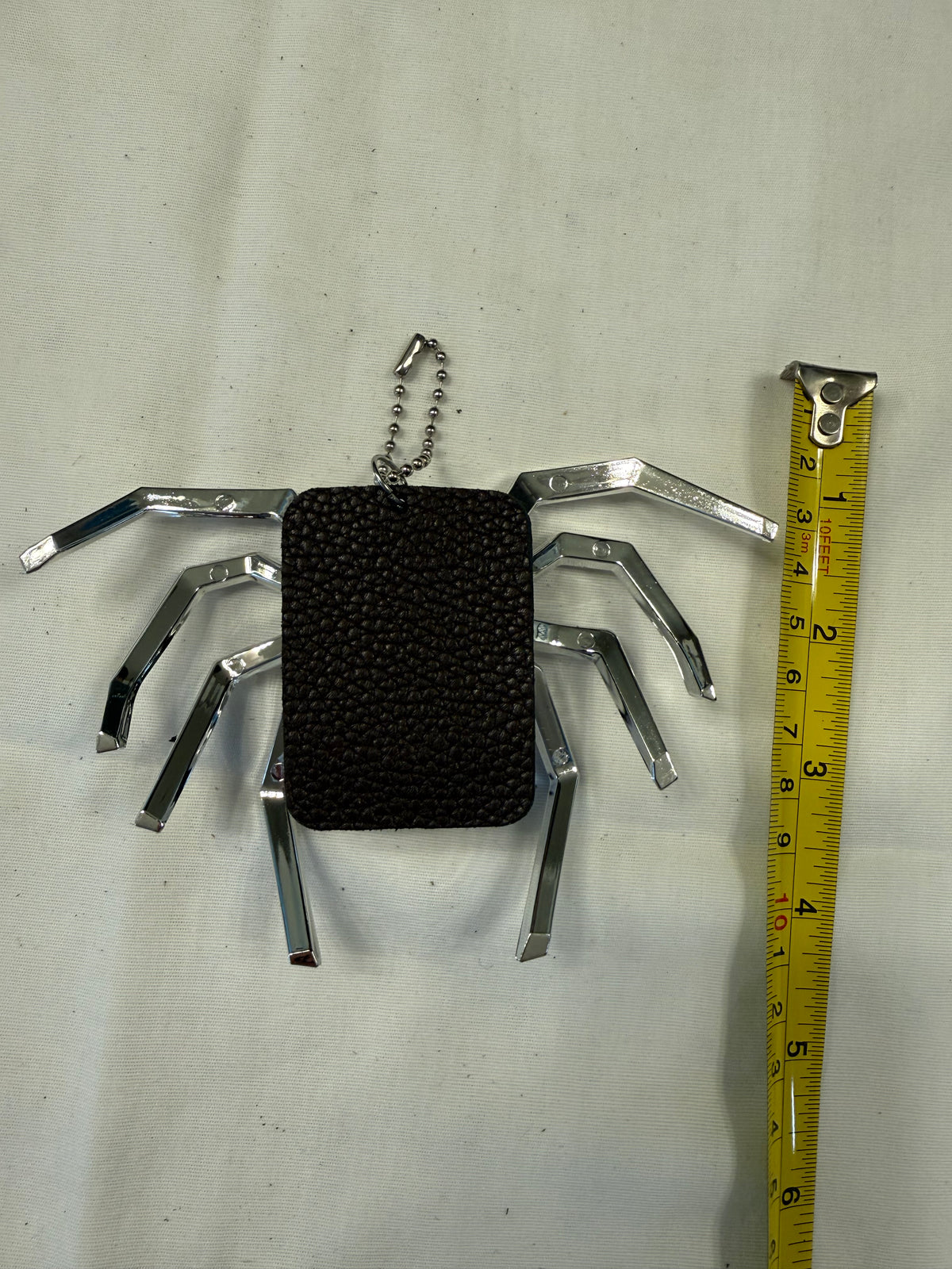 Metallic Plastic Spider on a Piece of a Coach Lora Bucket Bag Hangtag Style Charm