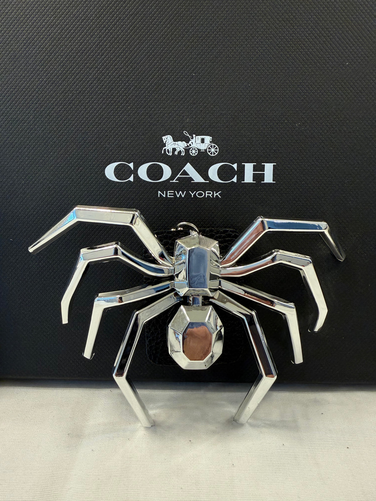 Metallic Plastic Spider on a Piece of a Coach Lora Bucket Bag Hangtag Style Charm