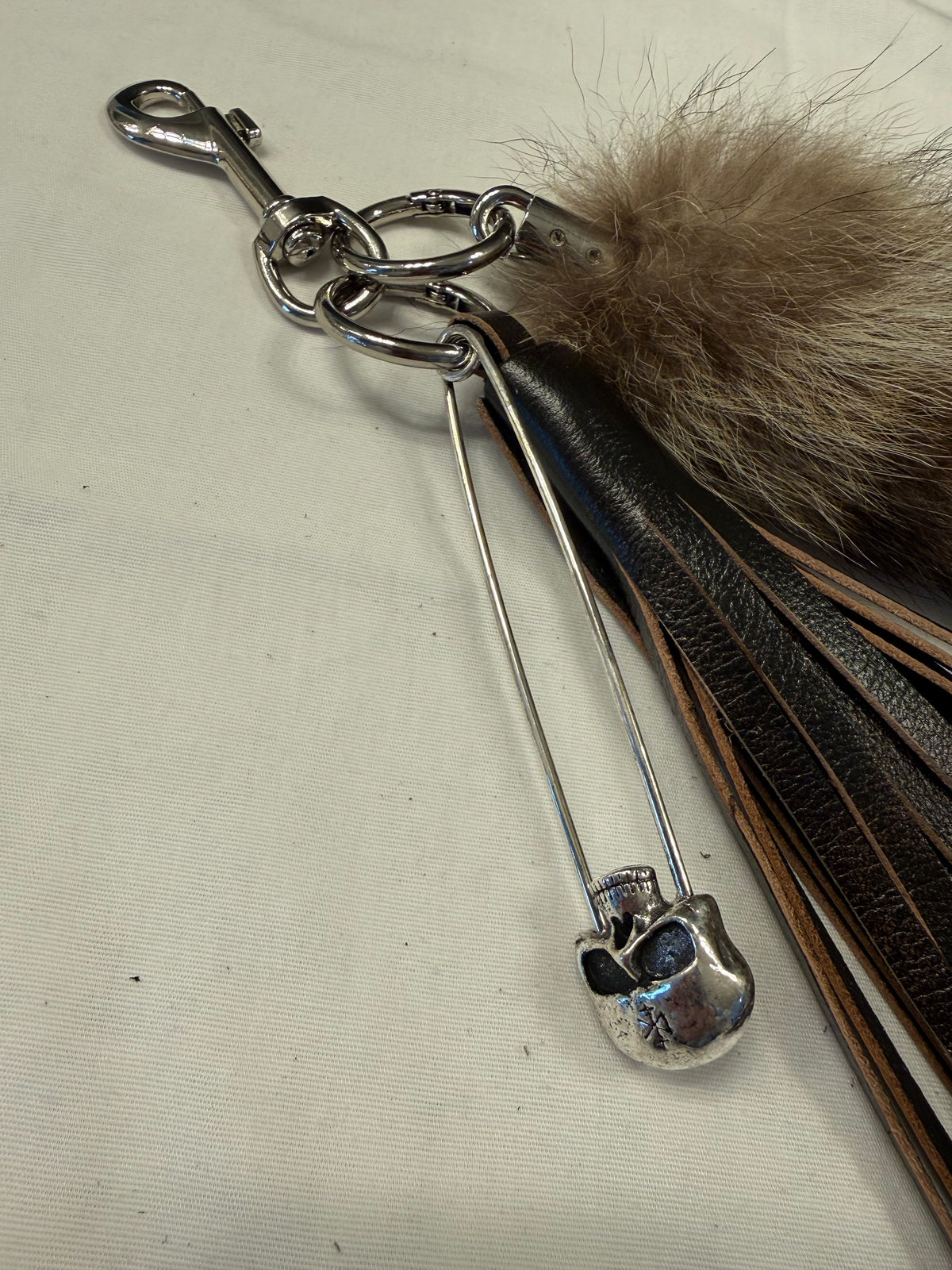 Handcut Painted Distressed Leather Tassel with Faux Fur Racoon Tail and Skull Safety Pin Bag Charm