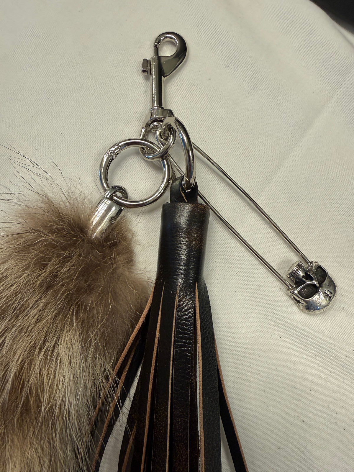 Handcut Painted Distressed Leather Tassel with Faux Fur Racoon Tail and Skull Safety Pin Bag Charm