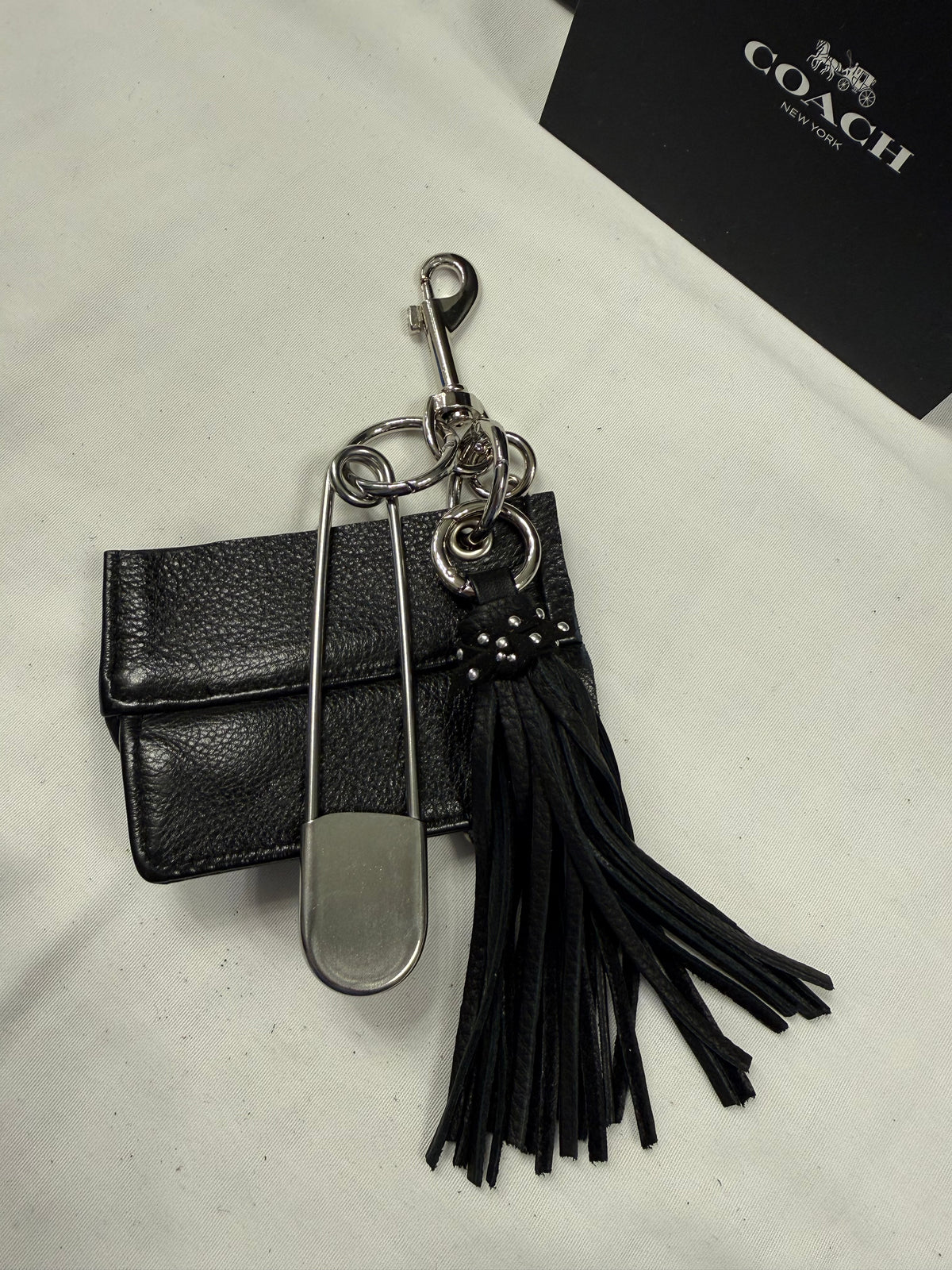 Repurposed Piece of a Coach Motorcycle Jacket, XL Safety Pin, Metal T-Rex, and Leather Tassel Bag Charm Cluster