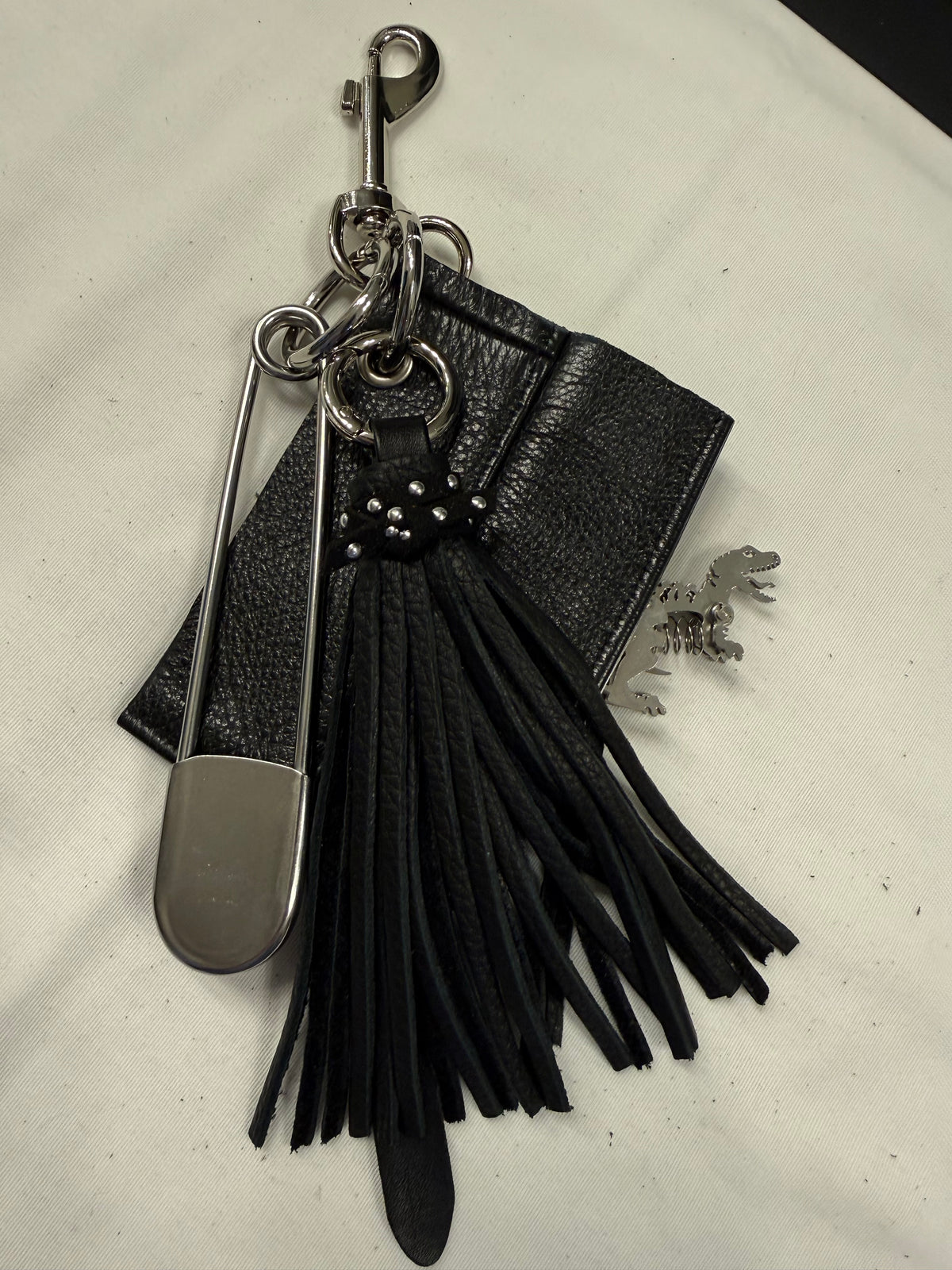 Repurposed Piece of a Coach Motorcycle Jacket, XL Safety Pin, Metal T-Rex, and Leather Tassel Bag Charm Cluster