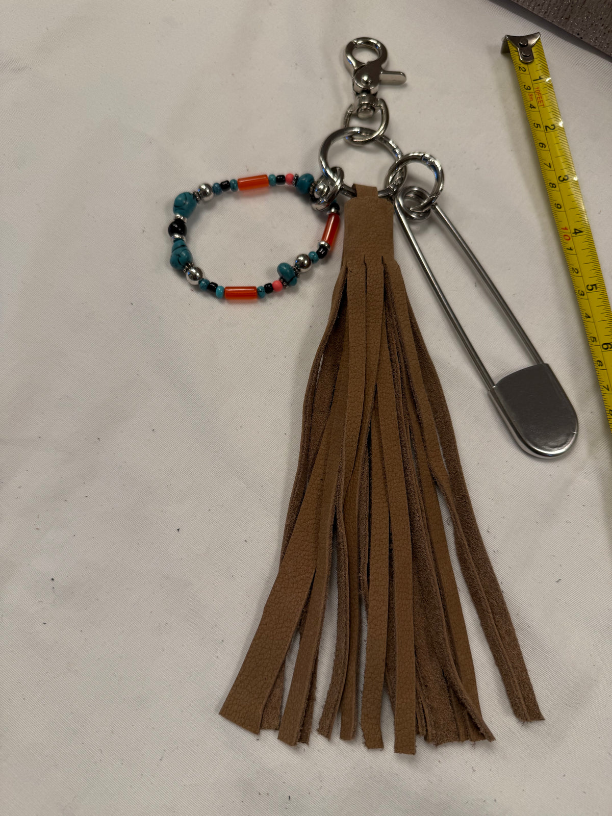 Bag Charm Cluster with Pebbled Leather Sandstone Tassel, Beaded Bracelet, and XL Safety Pin