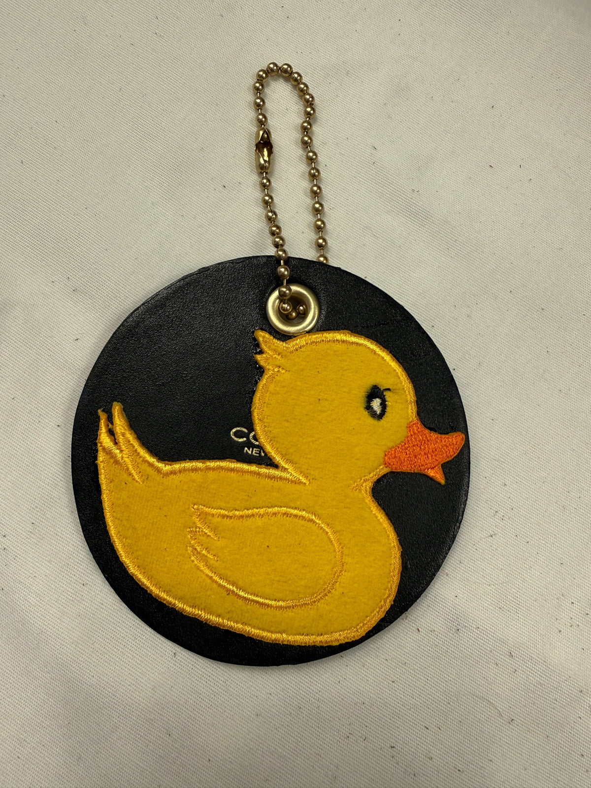 Repurposed Piece of a Coach Coaster Holder with a Rubber Ducky Patch Bag Charm