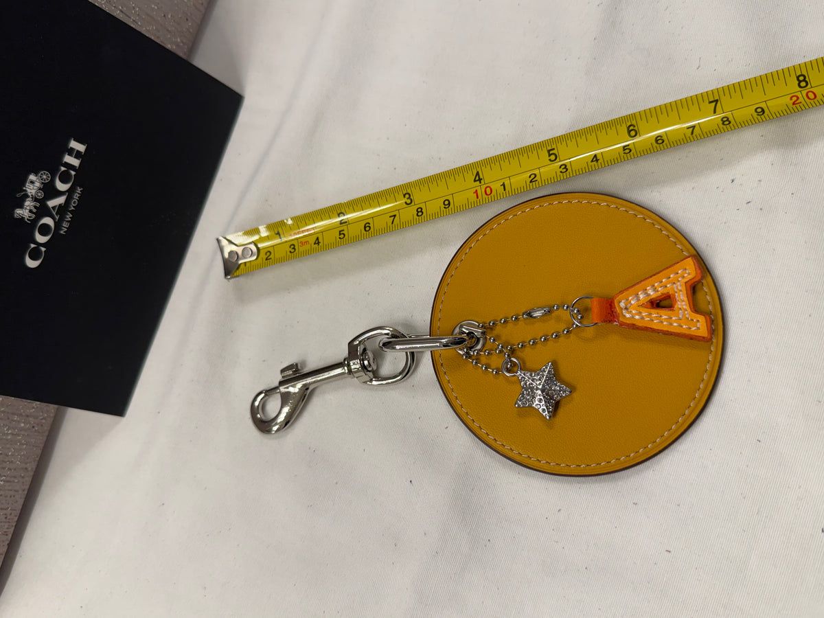 Repurposed Retro Coach Coaster with an A initial and a Coach Rhinestone Star Charm Bag Charm
