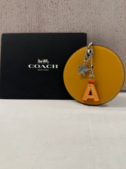 Repurposed Retro Coach Coaster with an A initial and a Coach Rhinestone Star Charm Bag Charm