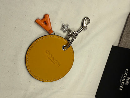 Repurposed Retro Coach Coaster with an A initial and a Coach Rhinestone Star Charm Bag Charm