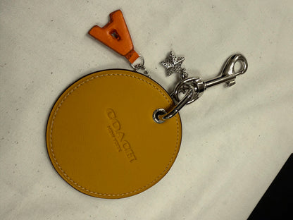 Repurposed Retro Coach Coaster with an A initial and a Coach Rhinestone Star Charm Bag Charm