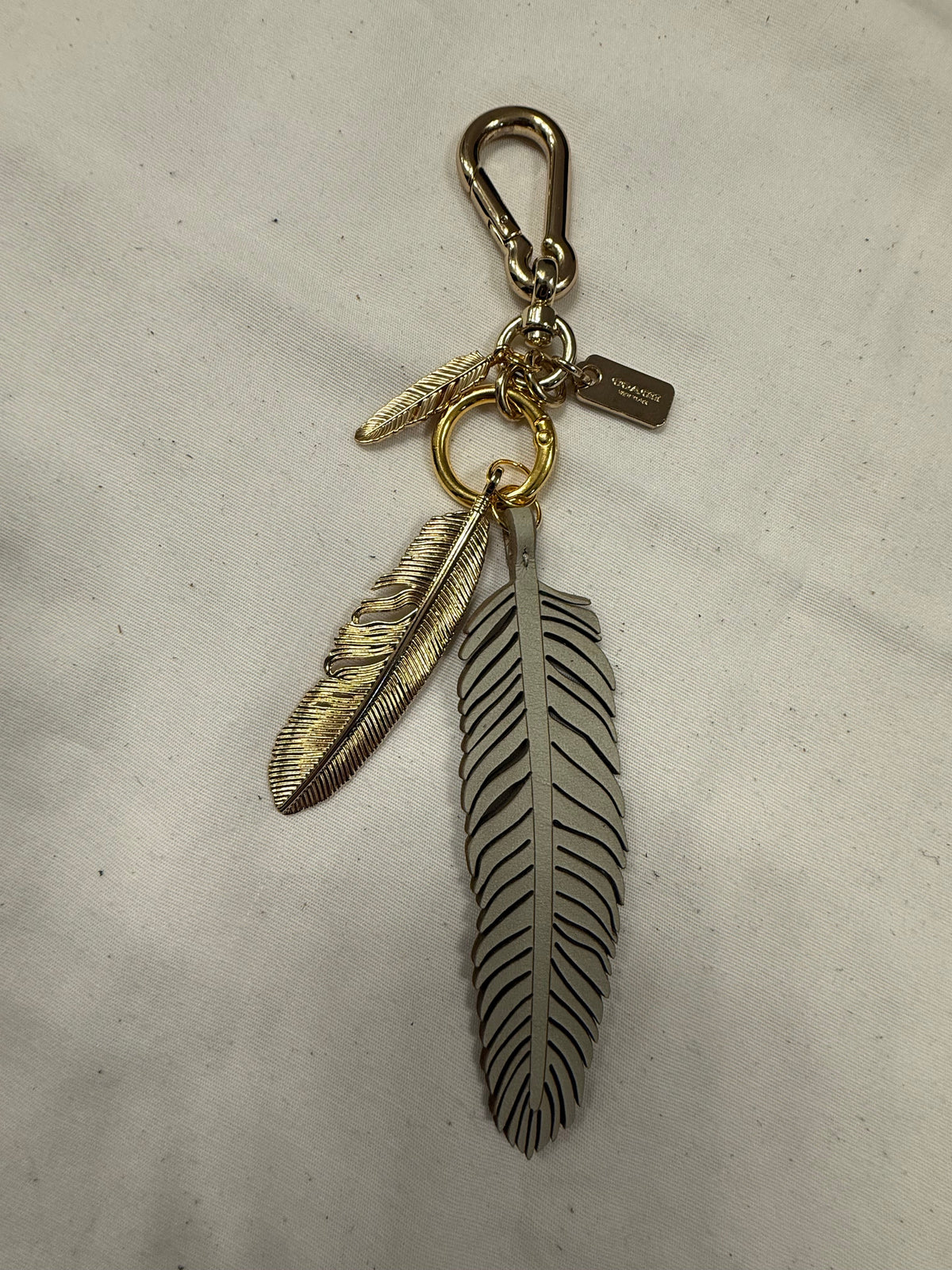Repurposed Coach Feather and Two Gold Tone Feather Charms on a Coach Clasp