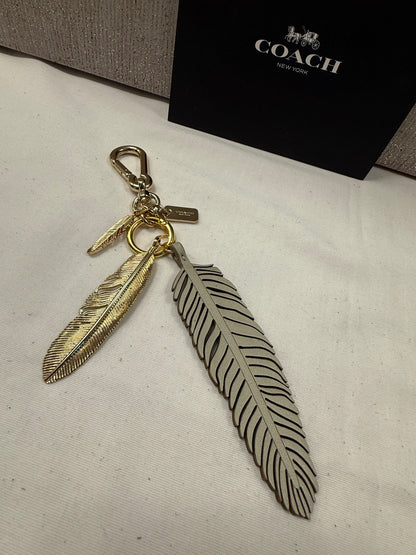 Repurposed Coach Feather and Two Gold Tone Feather Charms on a Coach Clasp