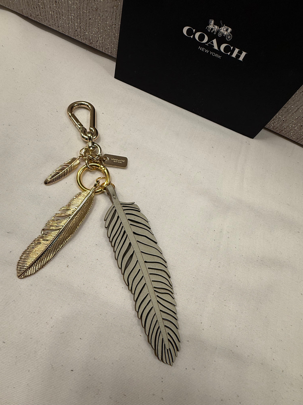 Repurposed Coach Feather and Two Gold Tone Feather Charms on a Coach Clasp