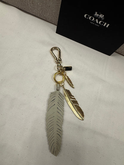 Repurposed Coach Feather and Two Gold Tone Feather Charms on a Coach Clasp