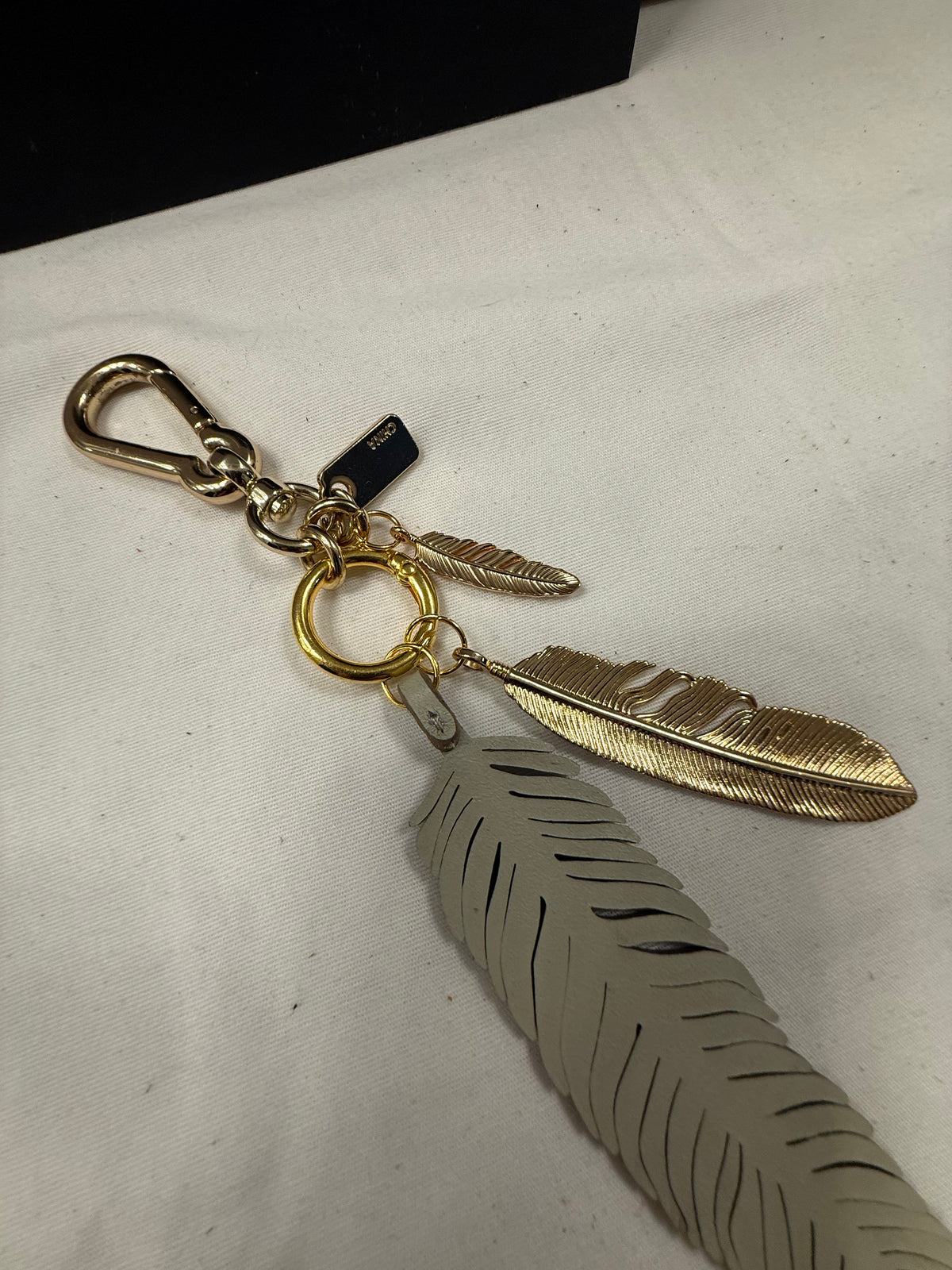 Repurposed Coach Feather and Two Gold Tone Feather Charms on a Coach Clasp