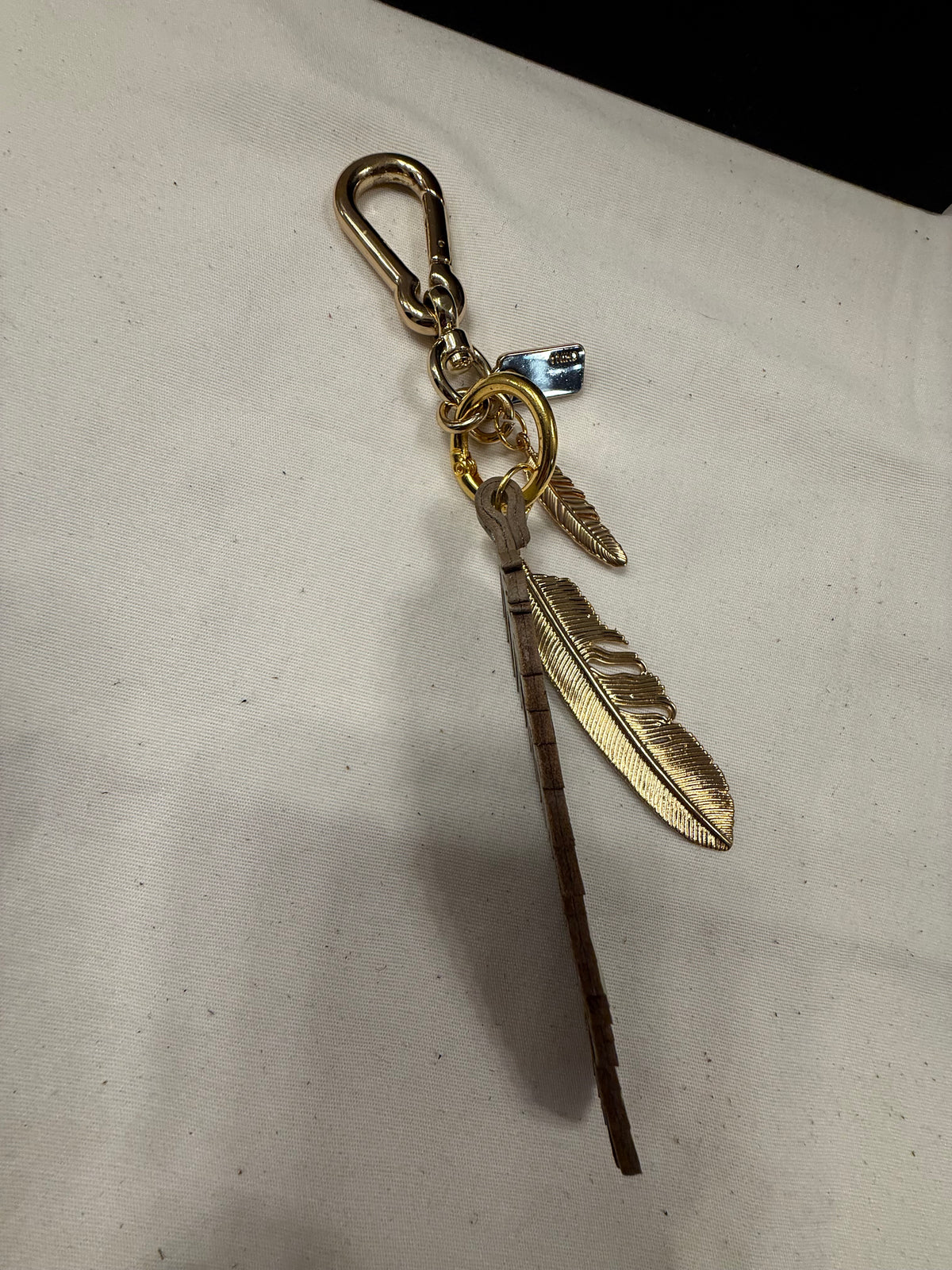Repurposed Coach Feather and Two Gold Tone Feather Charms on a Coach Clasp