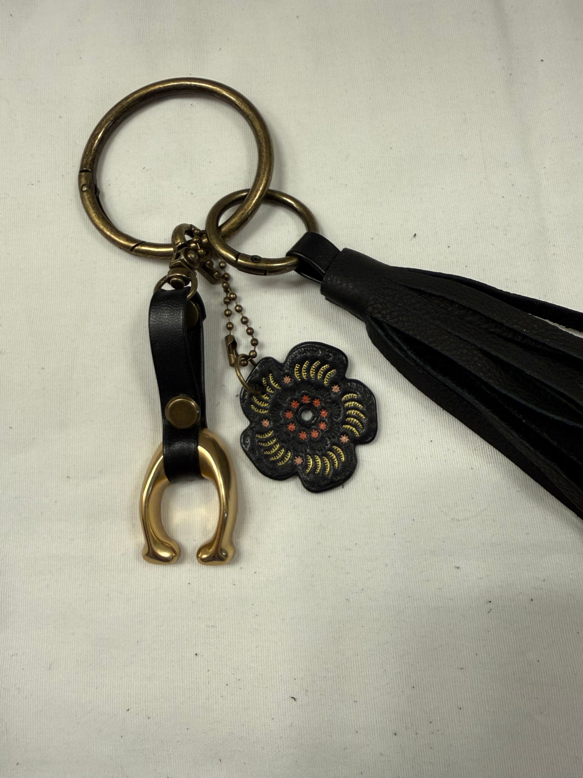Ships 10.13.26 Bag Charm Cluster with a Repurposed Coach C from Tic Tac Toe Board, Coach Tea Rose, and Handmade Leather Tassel Bag Charm Cluster
