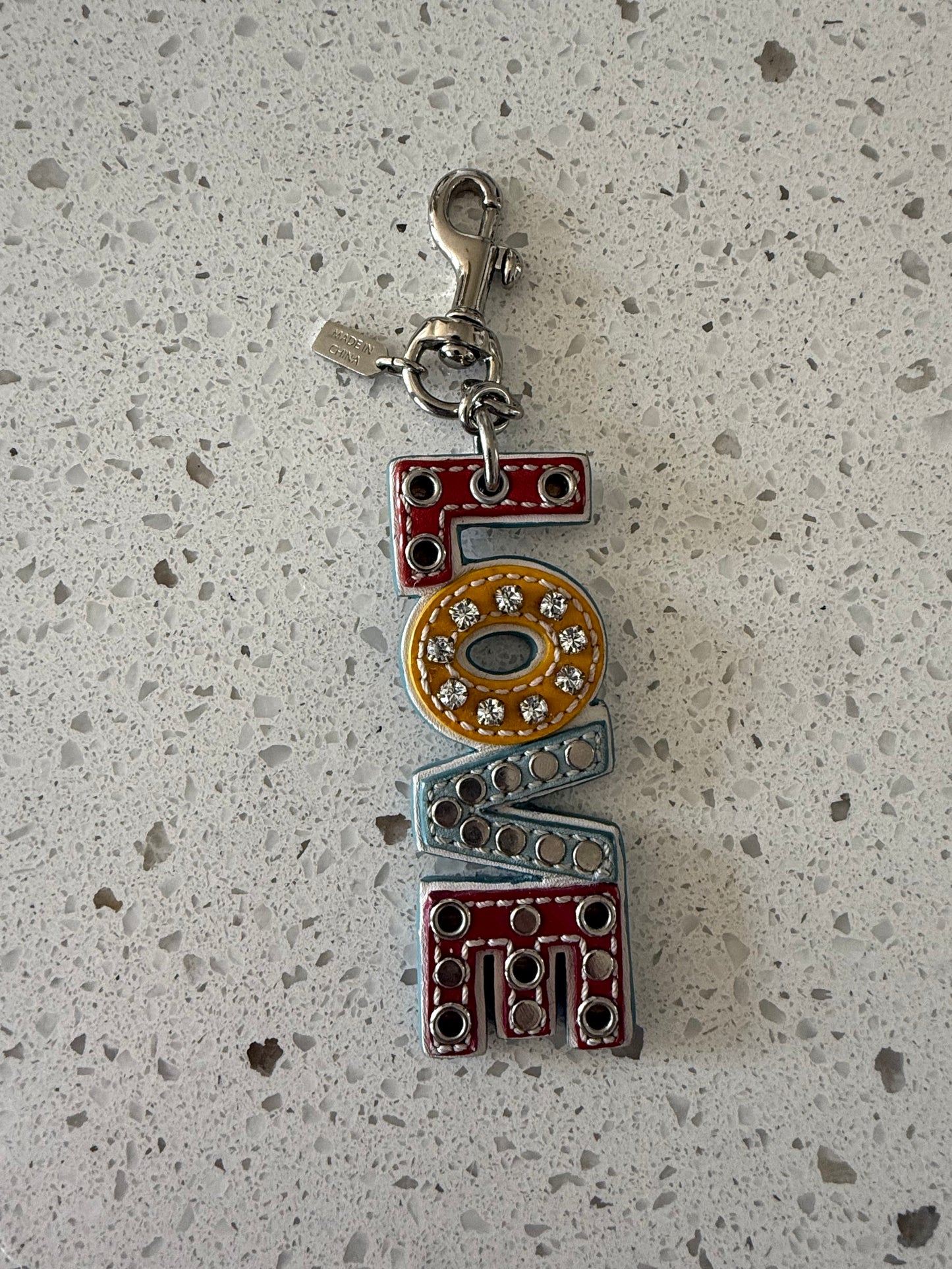 Pre-Loved Coach Multi-Color Leather "LOVE" Charm with Rhinestones Grommet Studs Optic C Print on the Back