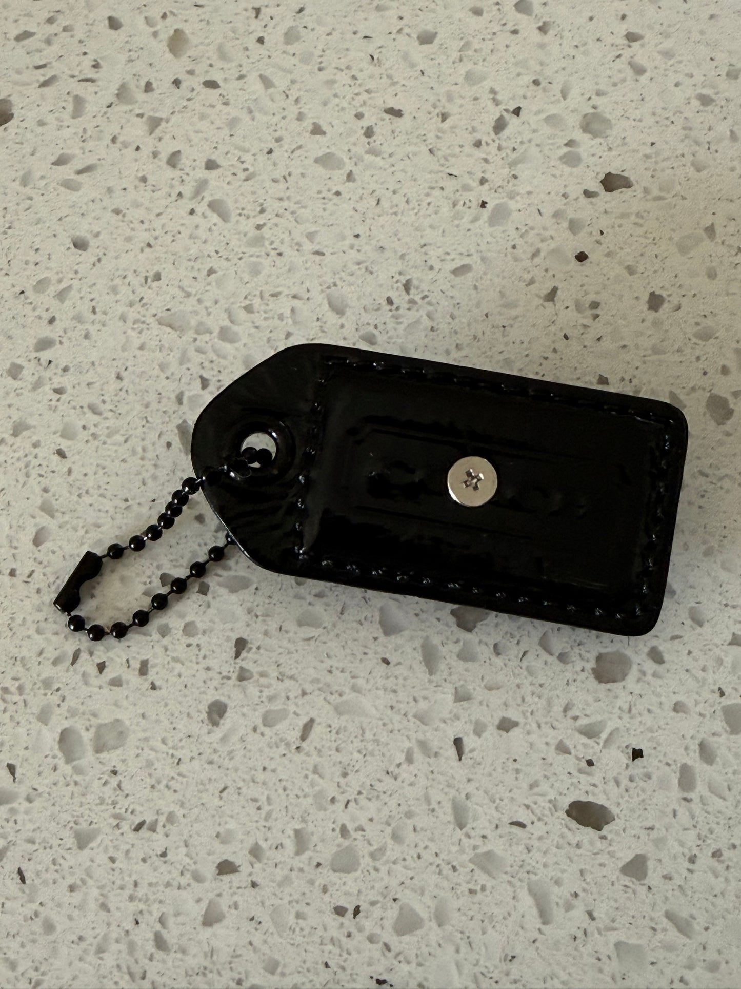 Repurposed Painted Black Coach Hangtag with Skull Rivet