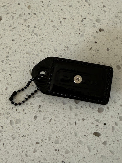 Repurposed Painted Black Coach Hangtag with Skull Rivet