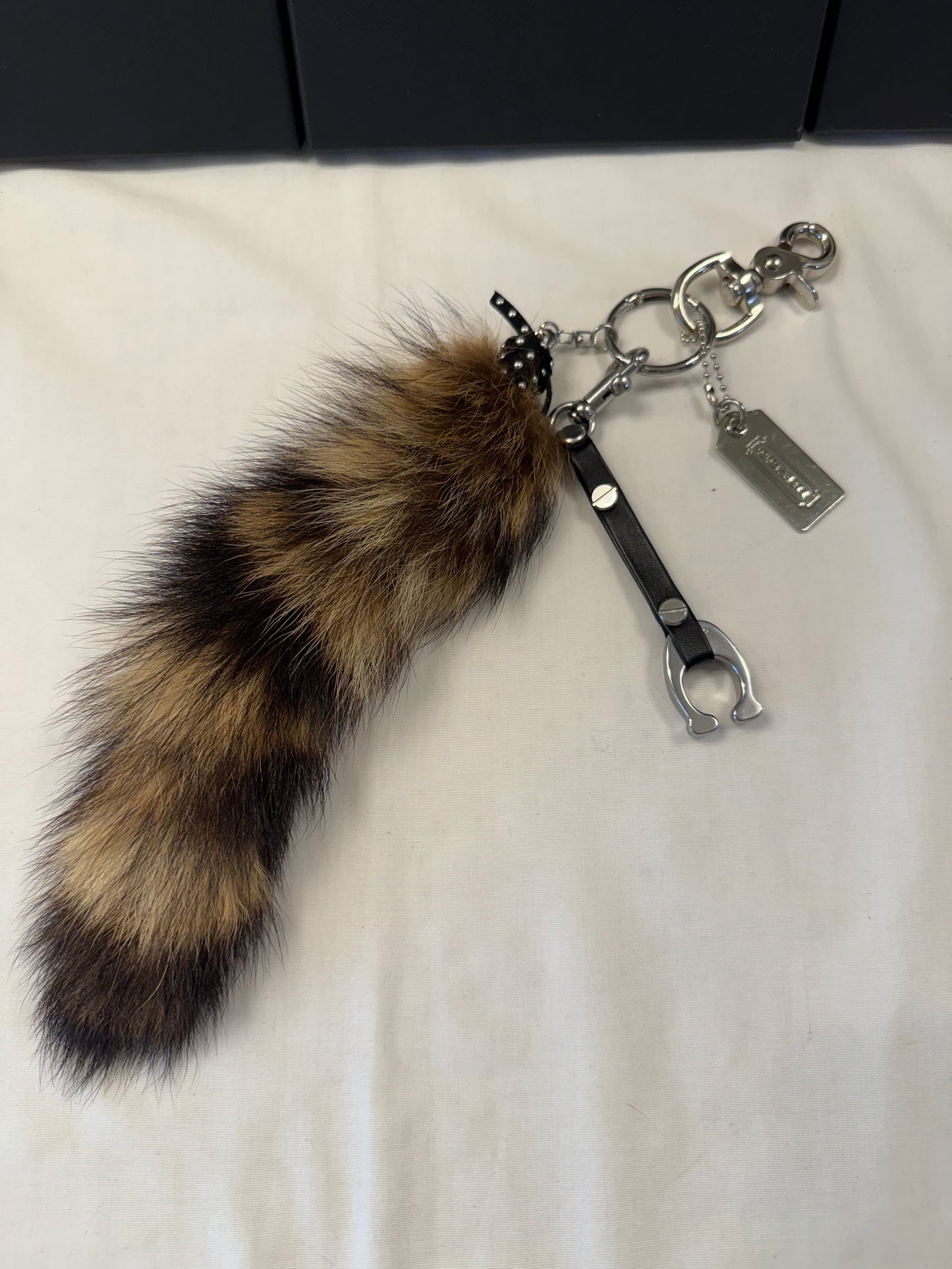 One-of-a-Kind Upcrafted Bag Charm Cluster | Faux Fur Raccoon Tail, Coach Tic Tac Toe "C" & Silver Coach Hangtag