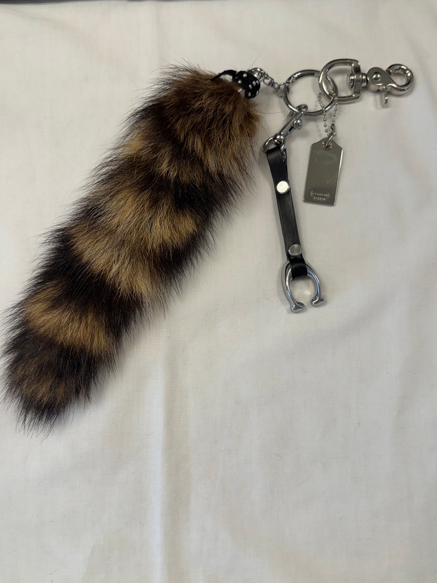 One-of-a-Kind Upcrafted Bag Charm Cluster | Faux Fur Raccoon Tail, Coach Tic Tac Toe "C" & Silver Coach Hangtag