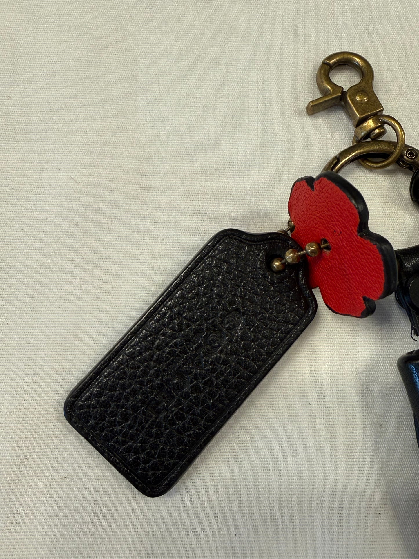One-of-a-Kind Upcrafted Coach Bag Charm Cluster | Black Leather Tassel, Tea Rose, Hangtag & Key Charm