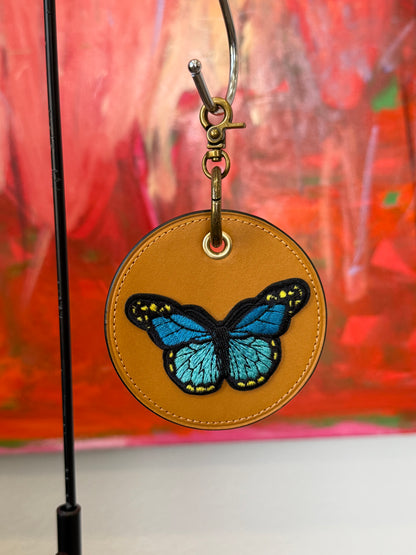 One-of-a-Kind Upcrafted Coach Coaster Bag Charm | Yellow Leather with Blue Butterfly Patch