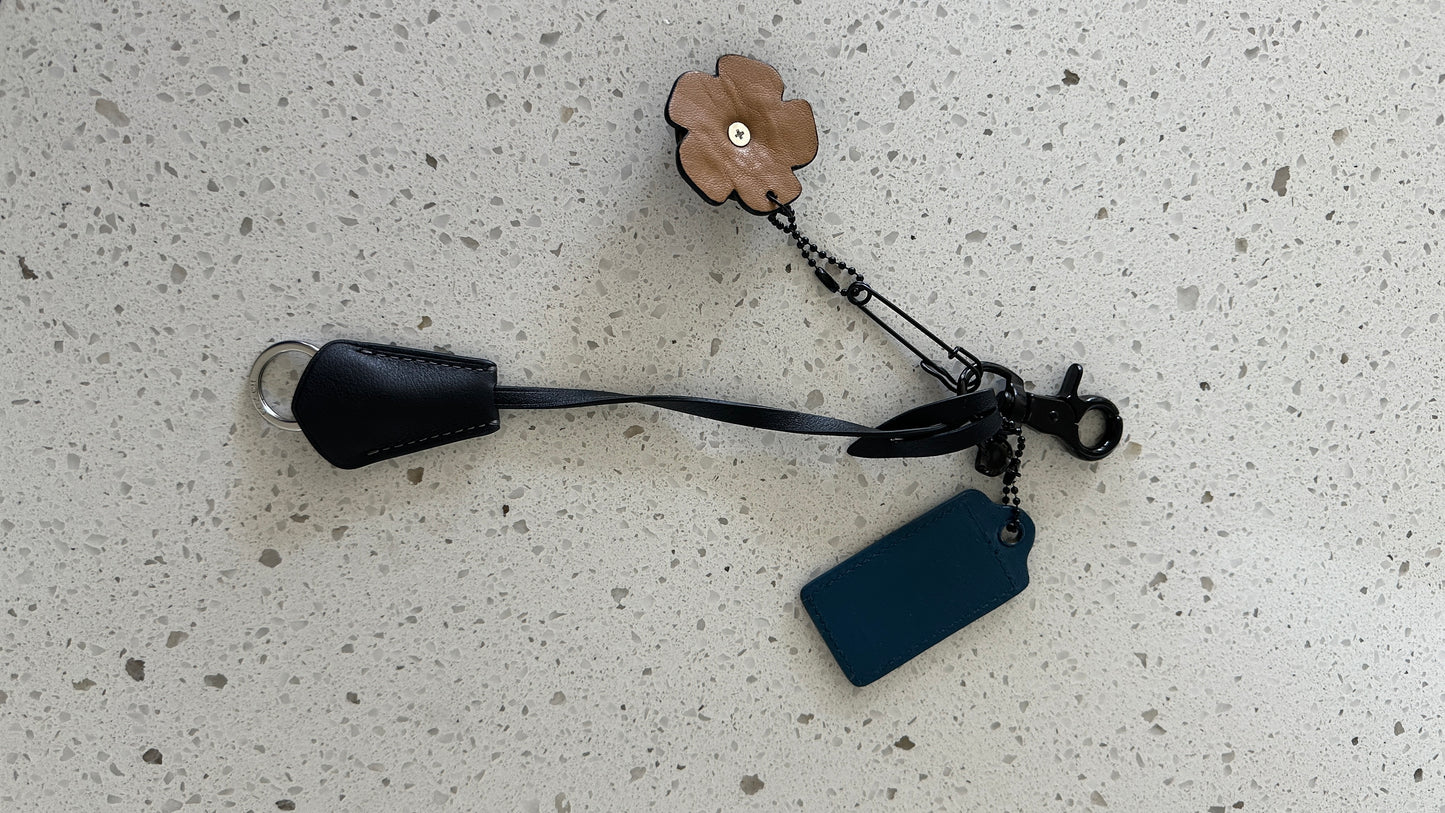 Coach Repurposed Leather Tea Roses with Skull Pin, Coach Clochette, and Painted Coach Hangtag with Black Skull Charm Bag Cluster