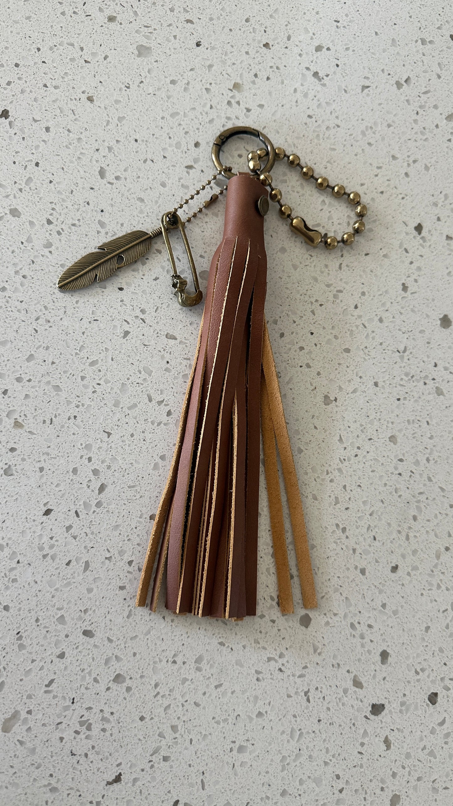 Bag Charm Cluster in Antique Brass with a Handmade Brown Leather Tassel, Coach Large Ball Chain, and Feather with Skull Safety Pin Charm