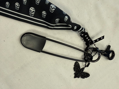 Bag Charm Cluster on Black Hardware with a Skull Scarf, XL Black Safety Pin, and Skull Moth Charm