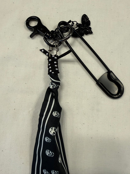 Bag Charm Cluster on Black Hardware with a Skull Scarf, XL Black Safety Pin, and Skull Moth Charm