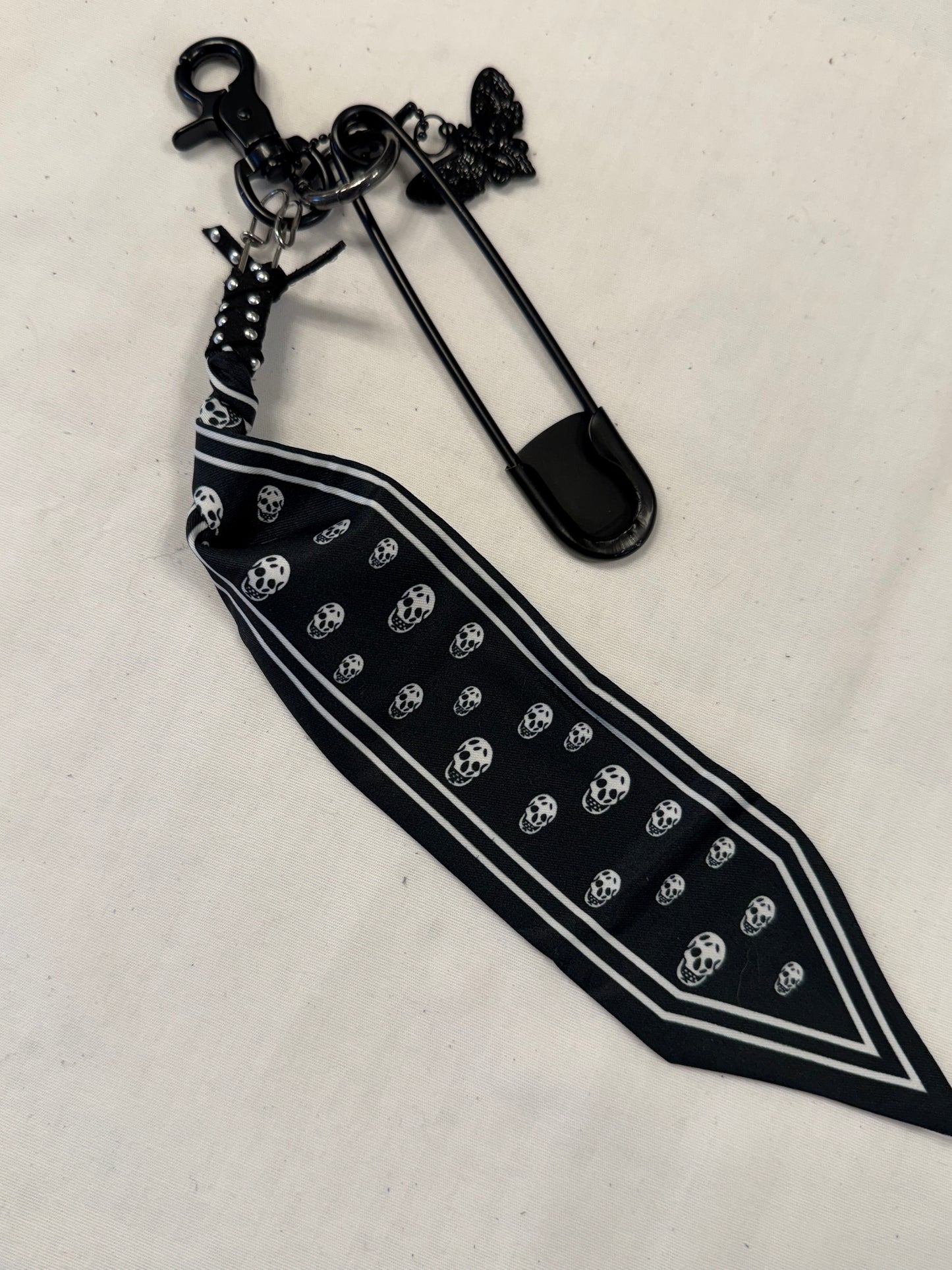 Bag Charm Cluster on Black Hardware with a Skull Scarf, XL Black Safety Pin, and Skull Moth Charm